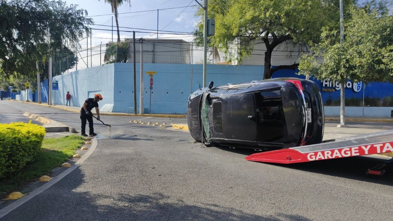 Impacta automóvil con banqueta y termina volcado
